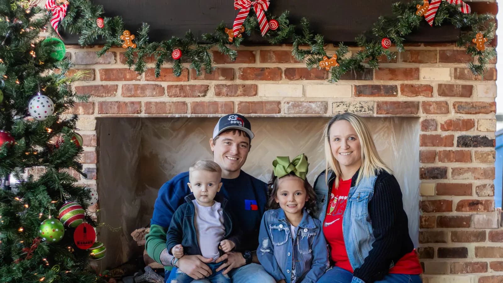 A team member's family seated by the fireplace at the In & Out No Doubt Christmas gathering