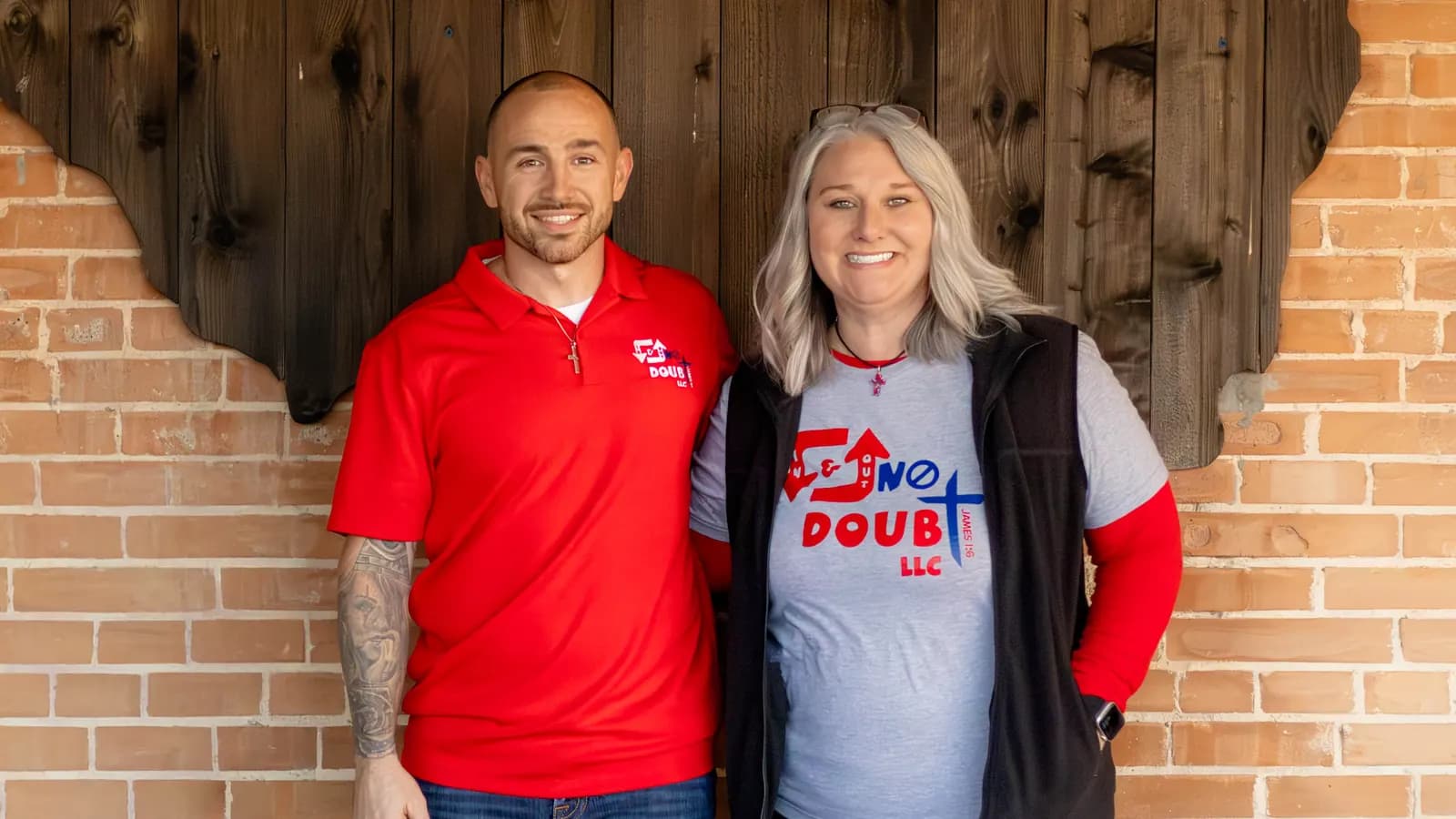 Hunter and Sheryl in In & Out No Doubt shirts, arm in arm in front of a wooden Texas cutout